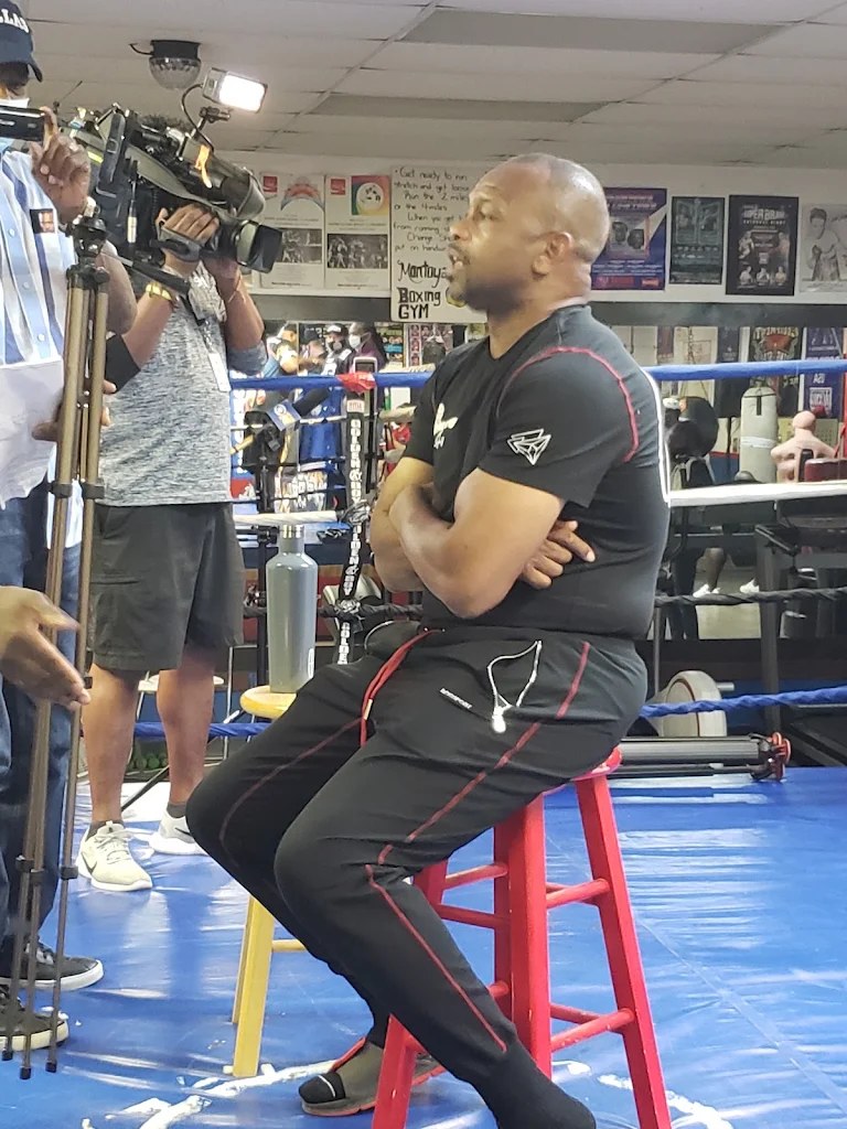 Roy Jones Jr. on a stool at Montoya Boxing Gym with a TV crew filming